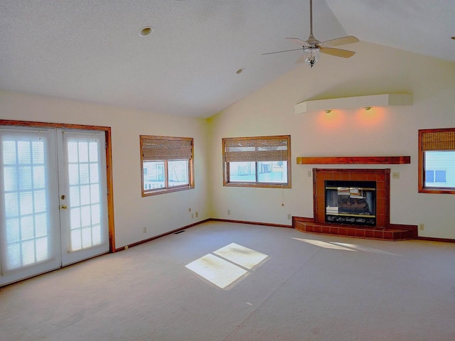 unfurnished living room featuring carpet floors, baseboards, and a tiled fireplace