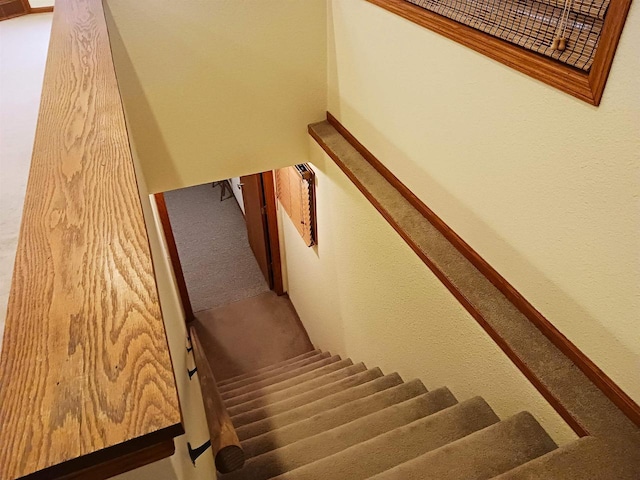 stairway with carpet flooring and baseboards