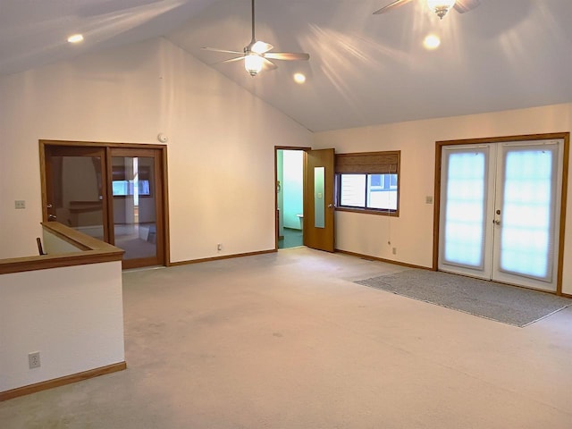 spare room with ceiling fan, high vaulted ceiling, french doors, and baseboards