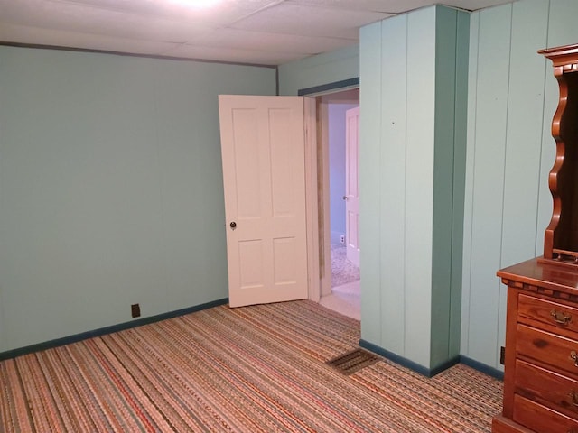 unfurnished bedroom featuring carpet and baseboards