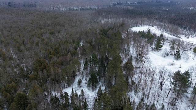 snowy aerial view featuring a view of trees