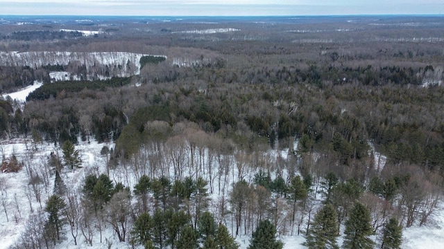 snowy aerial view with a view of trees