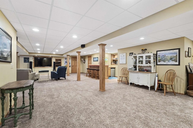 living room with decorative columns, carpet floors, a drop ceiling, a bar, and recessed lighting