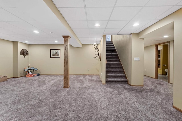 finished basement featuring carpet floors, baseboards, stairway, and recessed lighting