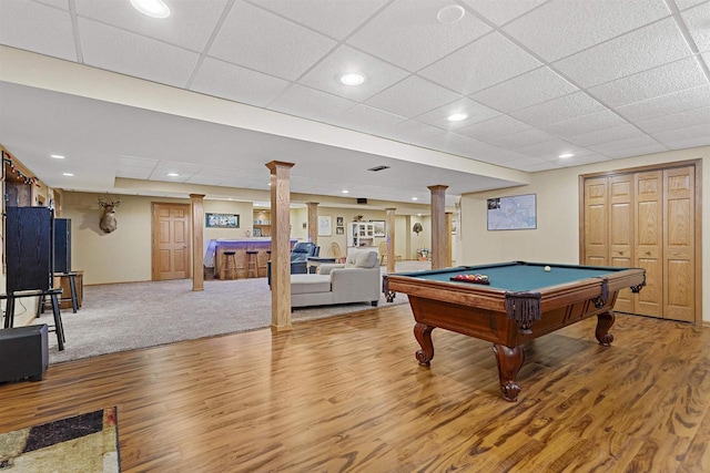 recreation room with decorative columns, wood finished floors, and recessed lighting