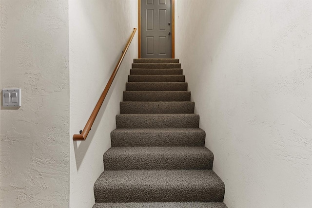 staircase with a textured wall