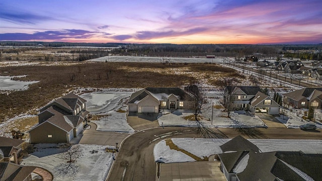 snowy aerial view featuring a residential view