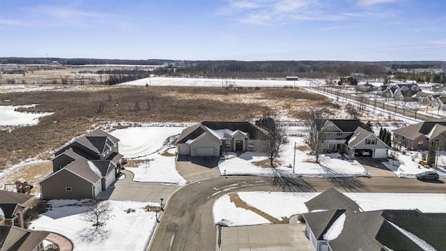 snowy aerial view featuring a residential view