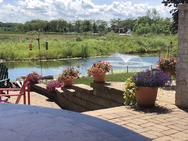 view of patio with a water view