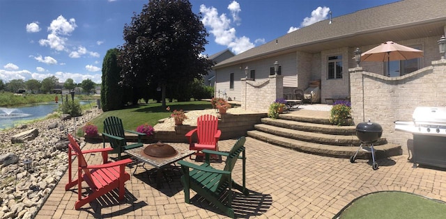 view of patio featuring a water view and grilling area