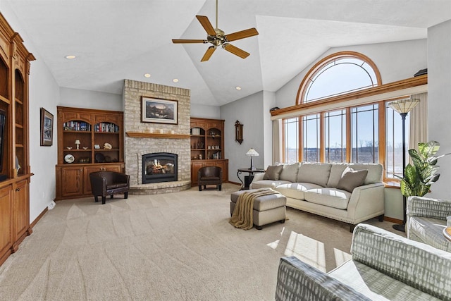 living room with ceiling fan, light colored carpet, a fireplace, baseboards, and built in features