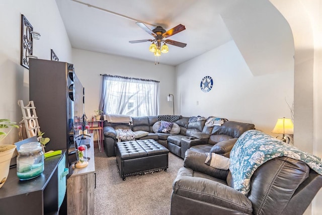 carpeted living room with ceiling fan