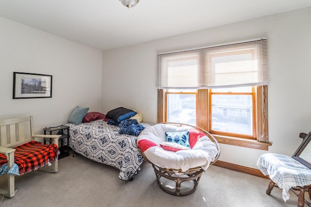 carpeted bedroom with multiple windows and baseboards