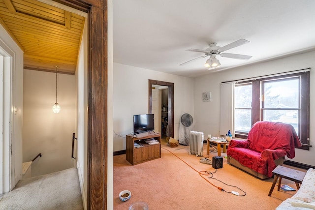 living room featuring carpet floors, radiator heating unit, wooden ceiling, and a ceiling fan