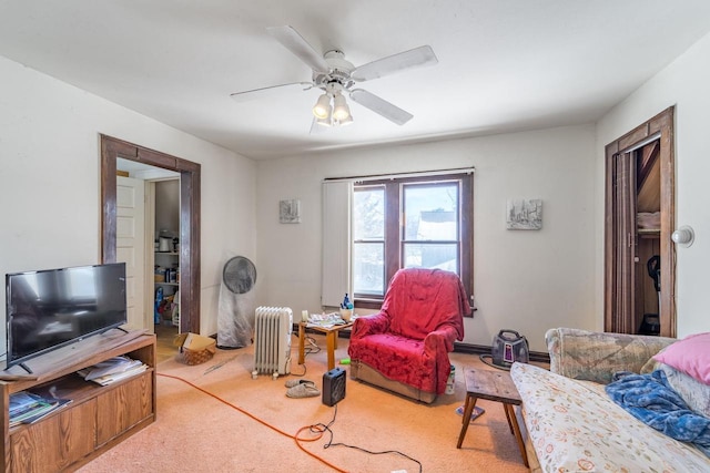 carpeted living room with radiator heating unit and a ceiling fan