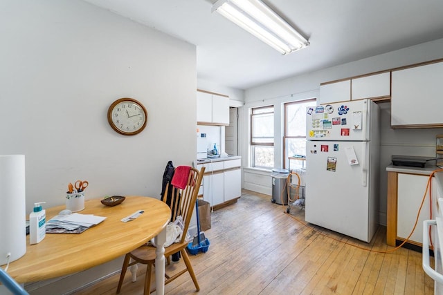 dining area featuring light wood-style flooring