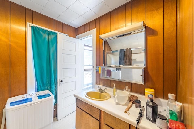 bathroom featuring wooden walls and vanity