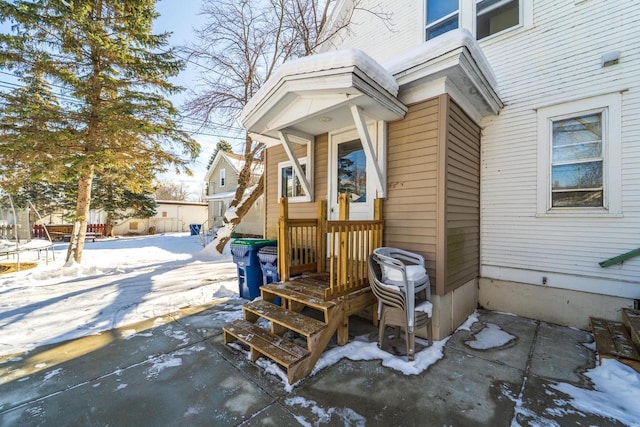 view of snow covered property entrance