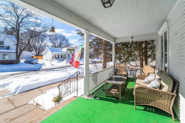 snow covered patio with covered porch