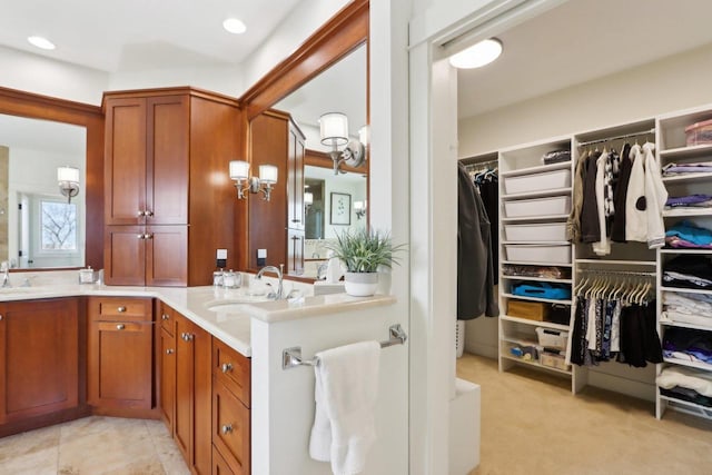 full bathroom with a spacious closet, double vanity, and a sink