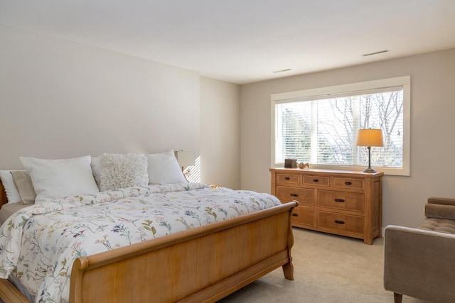 bedroom featuring light carpet