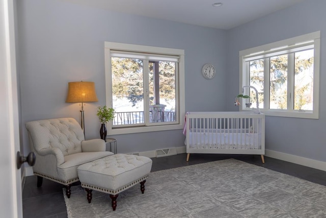 bedroom featuring multiple windows, visible vents, and baseboards