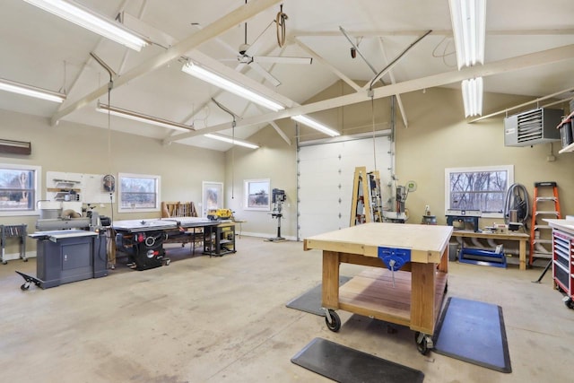 garage featuring ceiling fan, baseboards, and a workshop area