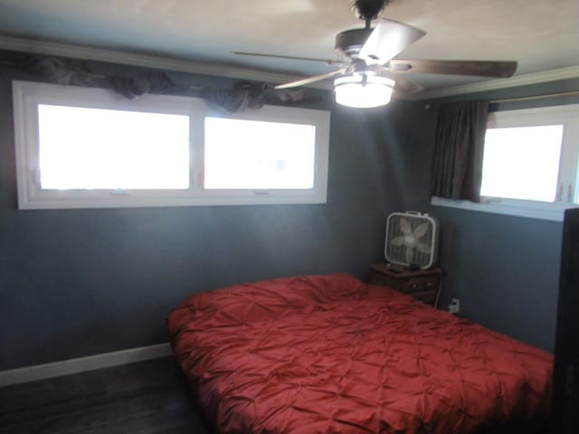 bedroom with ornamental molding, ceiling fan, and baseboards