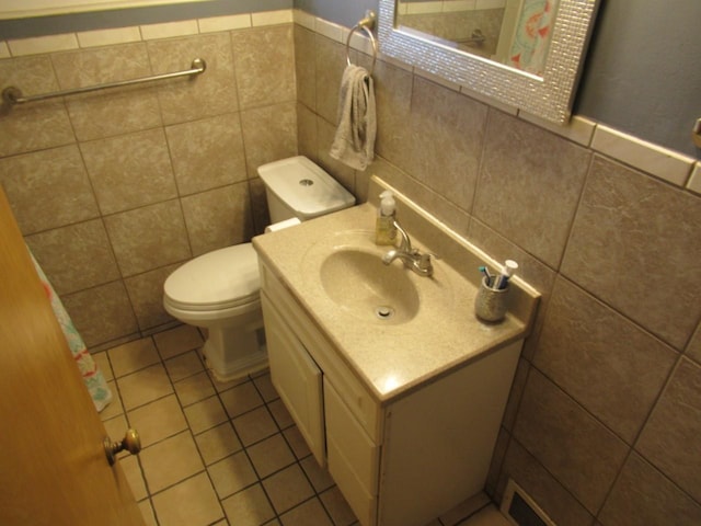 bathroom featuring tile walls, vanity, toilet, and tile patterned floors