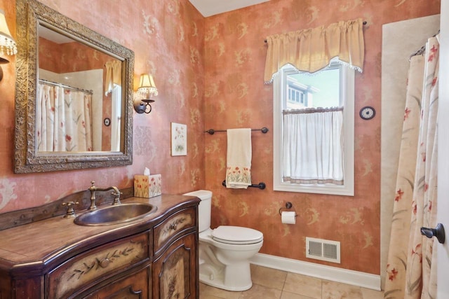 bathroom with baseboards, visible vents, toilet, tile patterned floors, and vanity