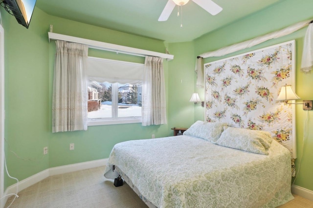 carpeted bedroom featuring a ceiling fan and baseboards