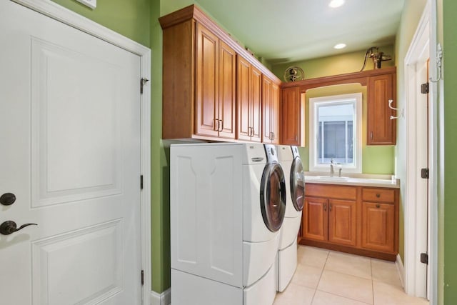 laundry room with recessed lighting, cabinet space, light tile patterned flooring, a sink, and separate washer and dryer