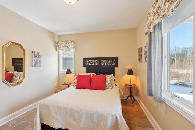 bedroom featuring multiple windows and baseboards