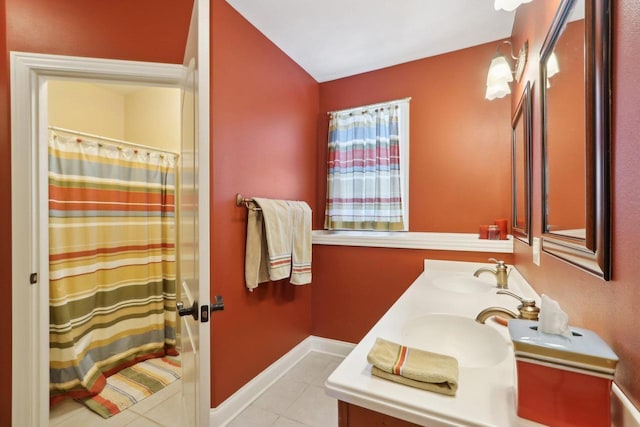 full bath featuring tile patterned flooring, a sink, baseboards, a shower with curtain, and double vanity