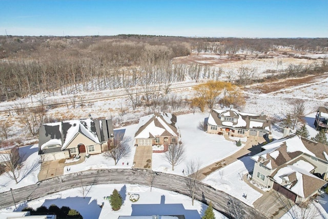 snowy aerial view with a residential view