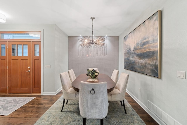 dining room with an inviting chandelier, visible vents, baseboards, and dark wood-style flooring