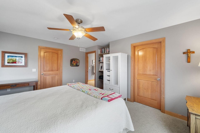 carpeted bedroom featuring ceiling fan, visible vents, and baseboards