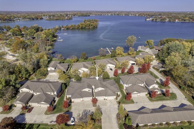 drone / aerial view with a water view and a residential view