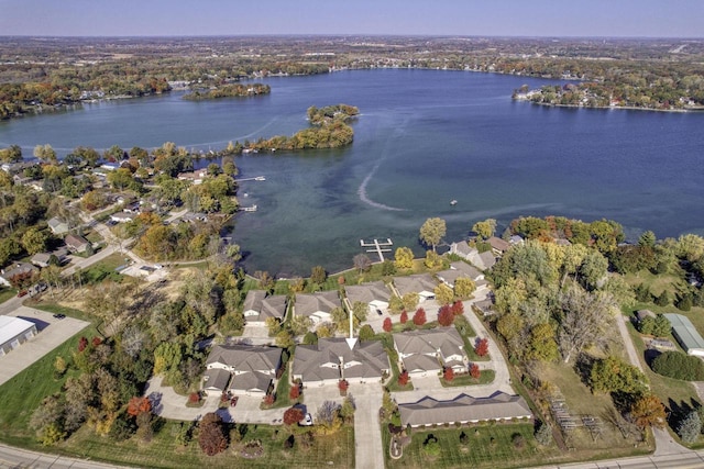 drone / aerial view featuring a water view and a residential view