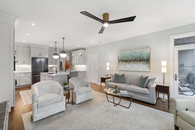 living room featuring ceiling fan, wood finished floors, and recessed lighting