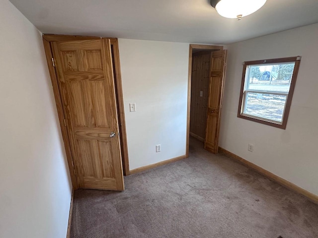 unfurnished bedroom with light carpet and baseboards