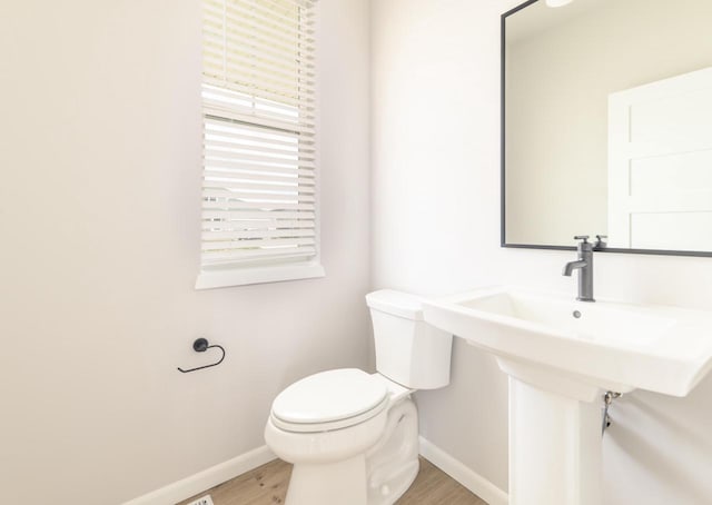 8012 Laufenberg Blvd, Cross Plains, WI 53528 - half bathroom with wood finished floors, baseboards, and toilet