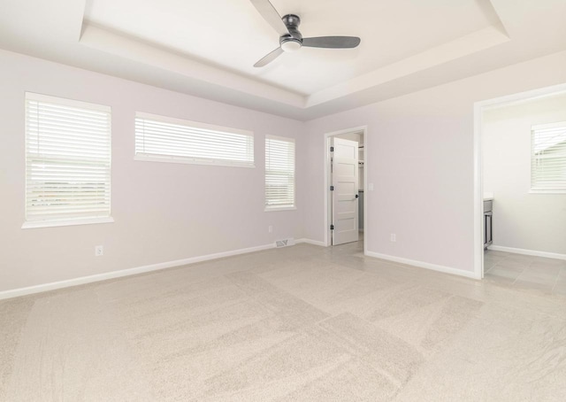 8012 Laufenberg Blvd, Cross Plains, WI 53528 - empty room featuring a tray ceiling, visible vents, a ceiling fan, light carpet, and baseboards
