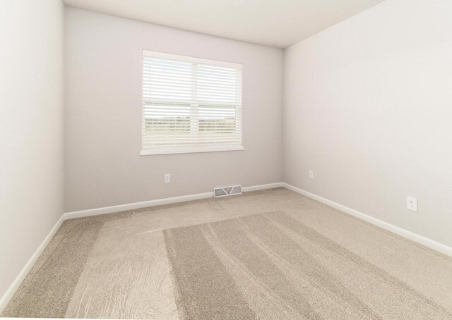 8012 Laufenberg Blvd, Cross Plains, WI 53528 - unfurnished room featuring carpet floors, visible vents, and baseboards