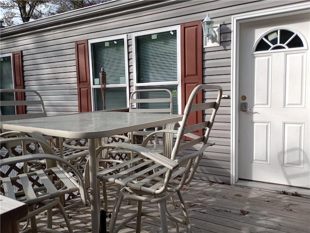 wooden terrace with outdoor dining space