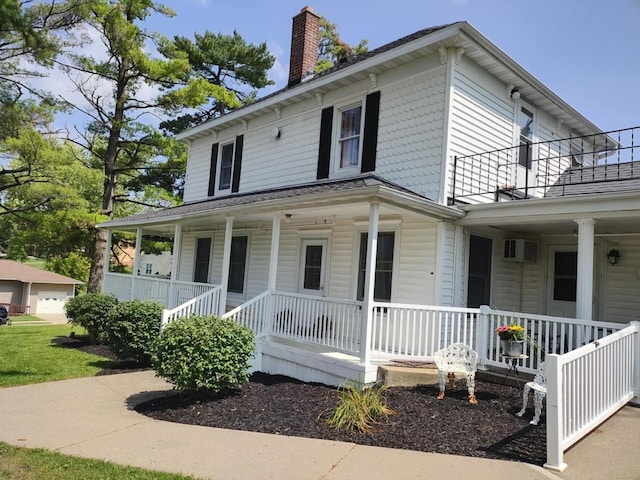 view of front facade with covered porch and a chimney