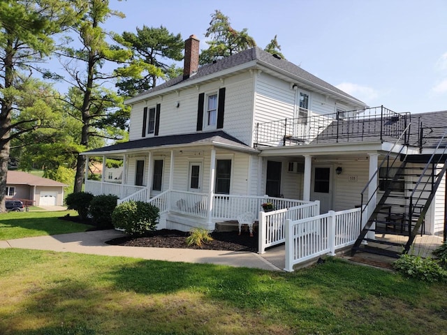 view of front facade featuring stairway, covered porch, a chimney, and a front lawn