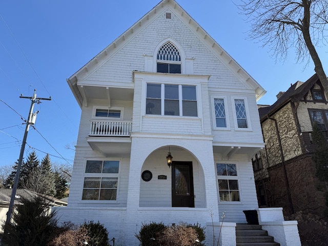 view of front of home with covered porch and brick siding