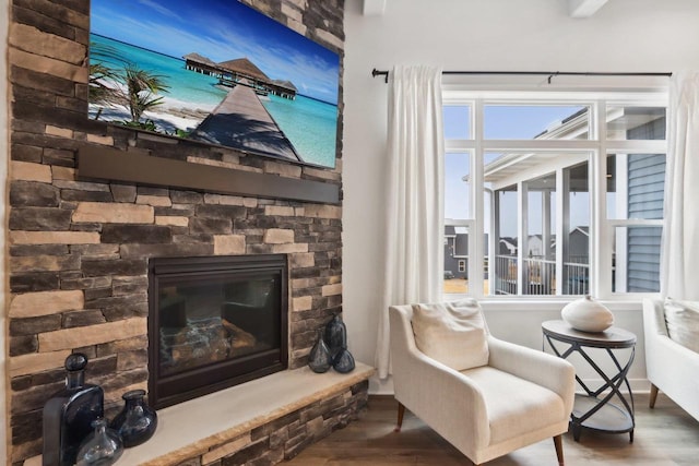 sitting room featuring a fireplace and wood finished floors