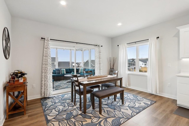 dining space featuring recessed lighting, plenty of natural light, baseboards, and wood finished floors